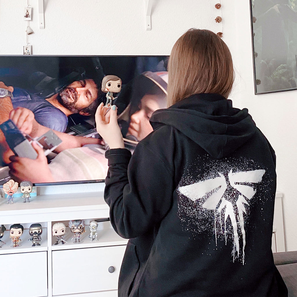 Image produit The Last of Us - Sweat à capuche noir avec logo Fireflies